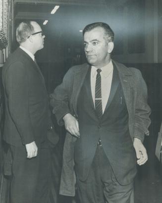 Arriving for hearing into death last October of 3-year-old Theresa McIntosh, child's father, Ian McIntosh (left), enters old city hall today. Shortly (...)