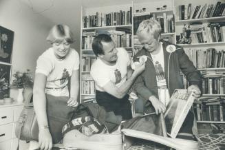 Bob McLean pins Canada Day button on wife Willa as daughter Jennie packs