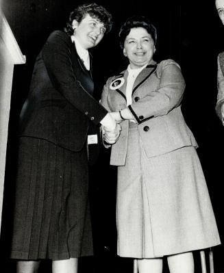 Bette Stephenson clasps Maureen McTeer's hand