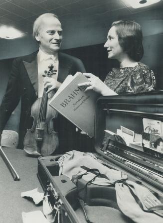 Yehudi and hephzibah Menuhin go over the program backstage at Massey Hall last night prior to their concert at which they presented one of the most or(...)