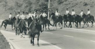 Tracking a rapist: Officers comb the Don Valley yesterday in the largest search yet for sex offender Fred Merrill