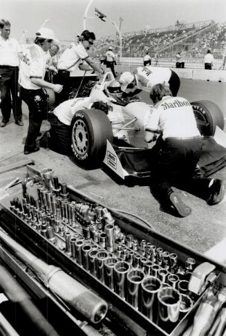 Rick Mears in his car is surrounded by the Penske Racing team