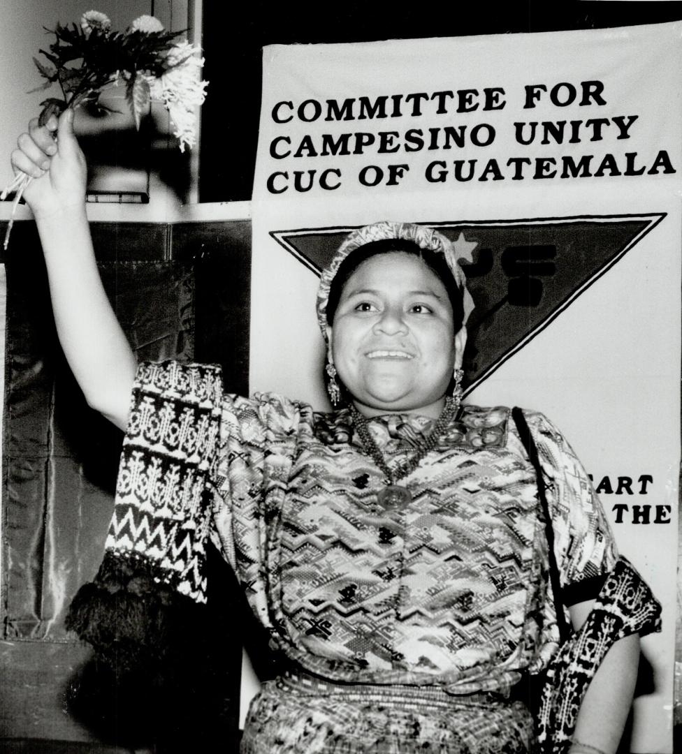 Peace activist cheered: Rigoberta Menchu acknowledges a standing ovation last night as she speaks to 1,000 people at the University of Toronto