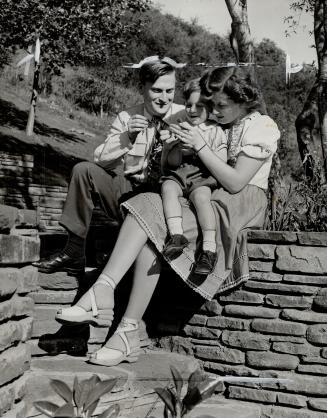 Yehudi Menuhin, his wife and son, Krov, in an informal portrait taken at the edge of the Menuhin estate's pool