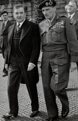 Leaving parliament buildings in Quebec City with Premier Maurice Duplessis, Field Marshal Viscount Montgomery is on his way to inspect the guard of honor