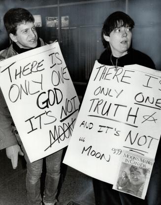 Signs of protest: Protesters demonstrate outside Westbury Hotel where Moonies had their meeting this week