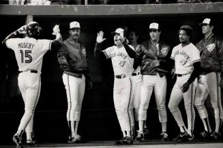 Game-Breaker: Lloyd Moseby is greeted at dugout after his eighth-inning homer gave the Jays a 7-6 win over the Indians