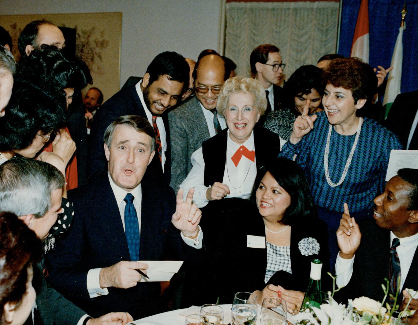 Centre of attention: Autograph-seekers surround Prime Minister Brian Mulroney after he delivered a speech at the Villa Colombo senior citizens' home