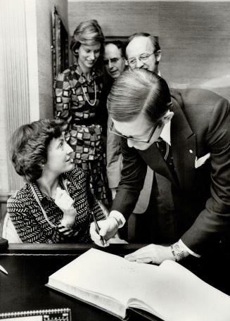 Princess Margriet of the Netherlands and her husband Pieter van Vollenhoven sign the guest book at luncheon hosted by the lieutenant-governor at Royal York