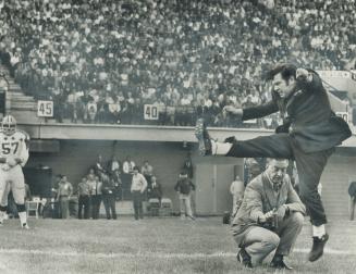 In a very healthy kickoff, Health Minister John Munro boots the ball down the field yesterday at Ottawa's Lansdowne Park to open Canadian Football Lea(...)