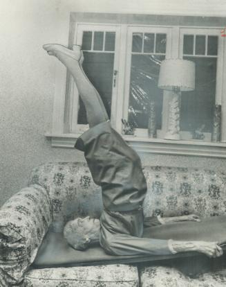 Despite pins in both her hips, 98-year-old Louise Tandy Murch does a yoga shoulder stand