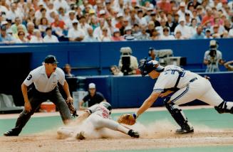 Too late, Boston's Tom Brunansky slides into home before Jays catcher Greg Myers can apply the tag in eighth inning yesterday. Boston won 1-0