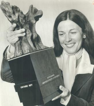 On target, Trap shooter Susan Nattrass holds Gerald Gladstone sculpture she received for outstanding amateur athletic achievement last night as the pr(...)