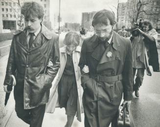 A distraught Susan Nelles flanked by two of her lawyers after an early court appearance