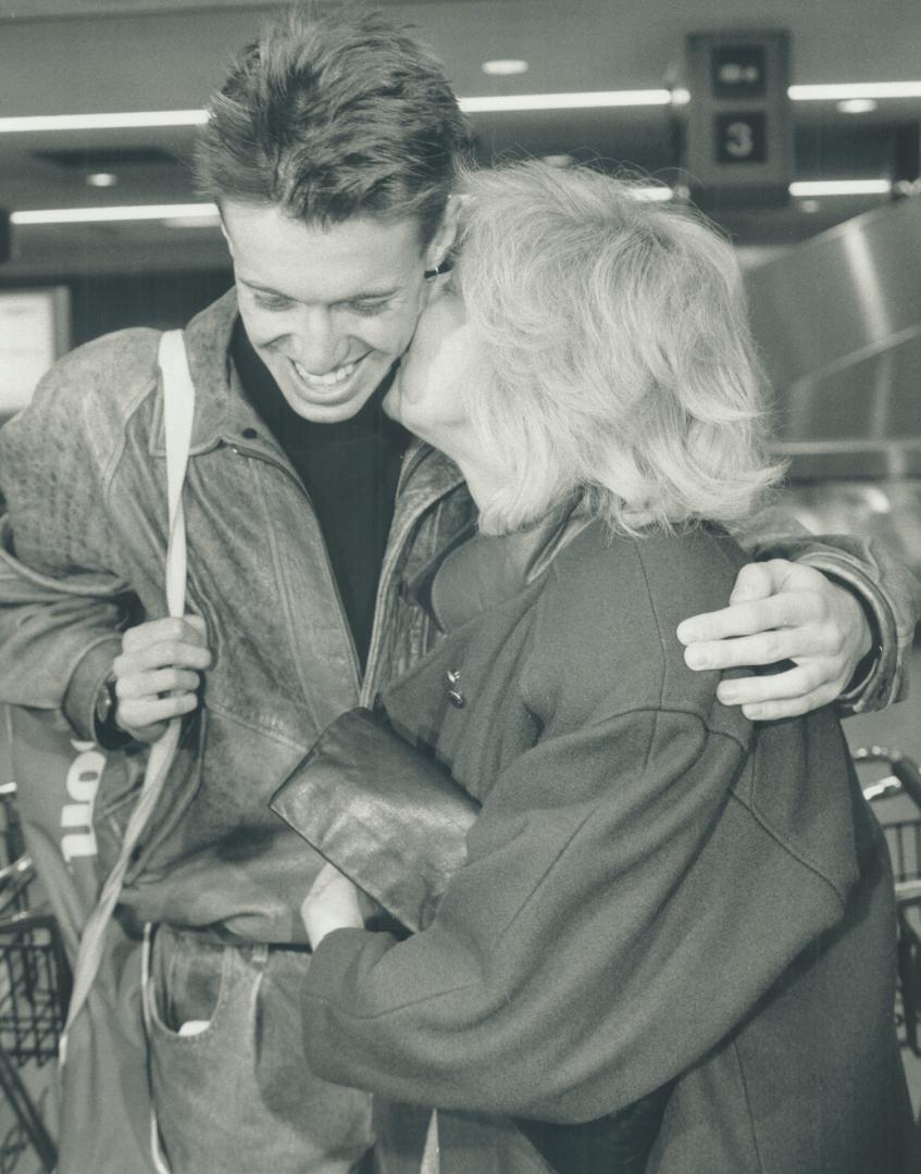 mom's pride and joy, Teenage tennis sensation Daniel Nestor gets a welcome-home kiss from his mother Anna yesterday after his Davis Cup upset victory