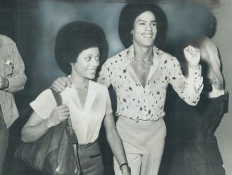 Fist raised in Black-Power salute, Black Panthers founder Huey Newton talks to reporters last night with his wife, Gwen, at his side. He had spent two(...)