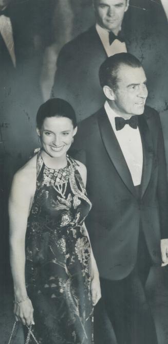 U.S. president Richard Nixon smiles at a remark of Margaret Trudeau, the Prime Minister's wife, as he escorts her into a concert in National Arts Cent(...)