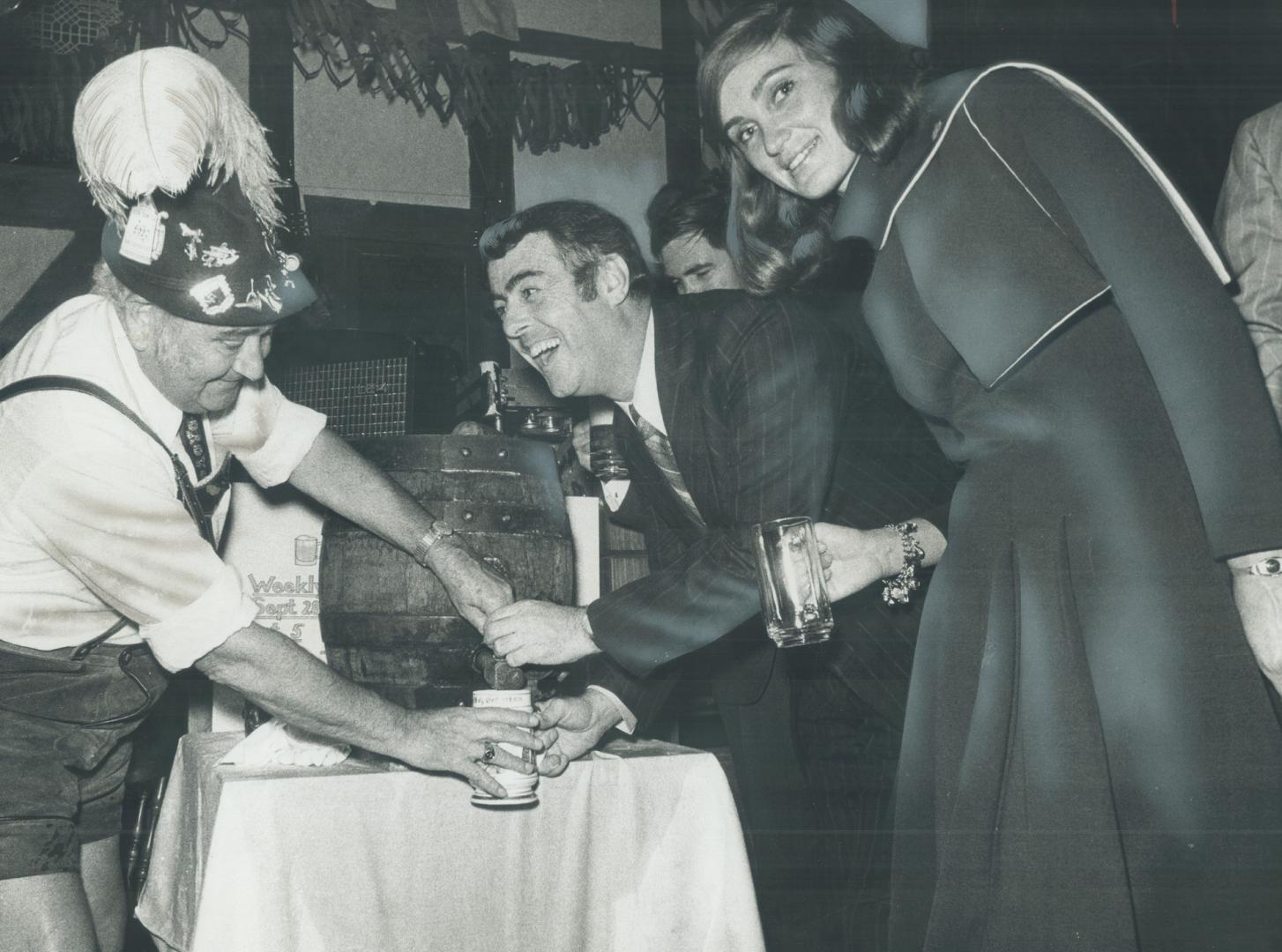 Alderman Tony O'Donohue and wife enjoy a taste from first keg of beer opened last night at the Oktoberfest at the Gasthaus Schrader German Country Inn(...)