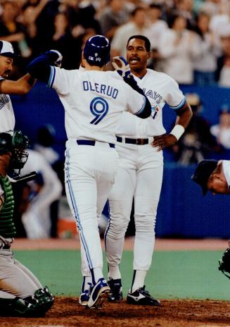 Big blow, Jays' John Olerud is met by Dave Winfield after his homer