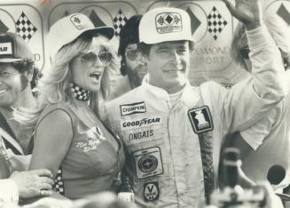 The fairest . . . . and fastest. Driver Danny Ongais acknowledges cheers yesterday after winning Molson Diamond Indy race at Mosport. To his right is (...)