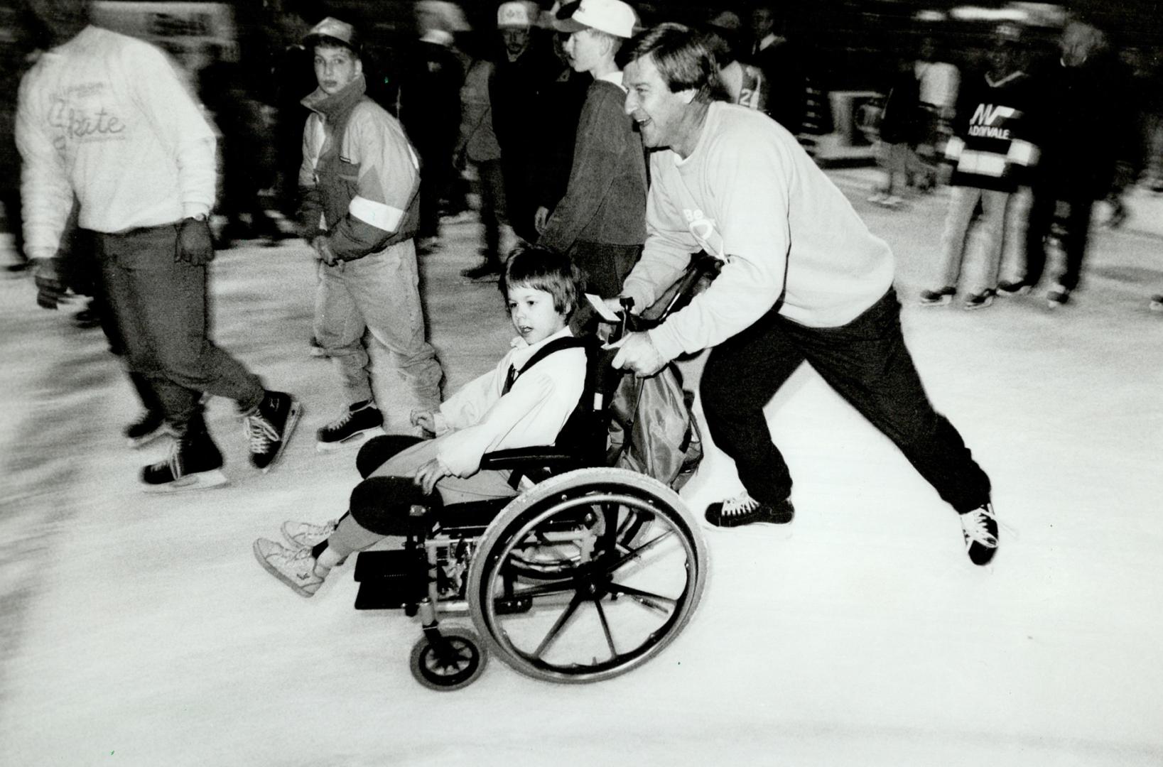 On the breakway, Former Boston Bruins great Bobby Orr gives Shannon Kerr, 7, the glide of a lifetime yesterday at the 12th annual celebrity skate for Easter Seals at Maple Leaf Gardens