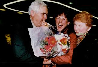 Gold medal skier Kate Pace, 24, of North Bat, lands at Pearson International Airport last night en route from Japan to hugs, kisses and flowers from proud parents Angela and Murray Pace