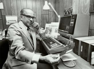 Word-man at work, Thomas Paikeday, lexicographer, with the specially designed computer system he is using to compile The New York Times Everyday Dictionary