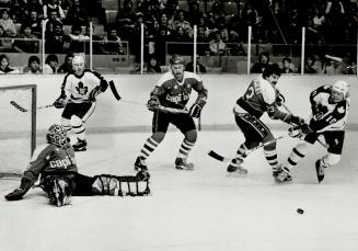 Help for Mike, Former Toronto goalie Mike Palmateer is vulnerable as he spawls in his crease, but he gets help from Dennis ververgaert (23) who checks Leafs' John Anderson last night