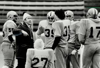 The quiet man, Hamilton Tiger-Cat head coach John Payne is surrounded by his players during yesterday's Grey Cup practice session