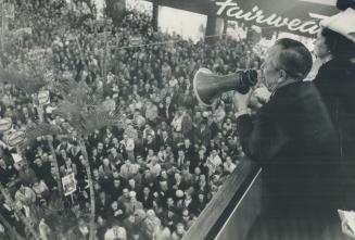 Even a loud-hailer doesn't help Prime Minister Pearson to be heard above the crowd noise at YorkDale Plaza