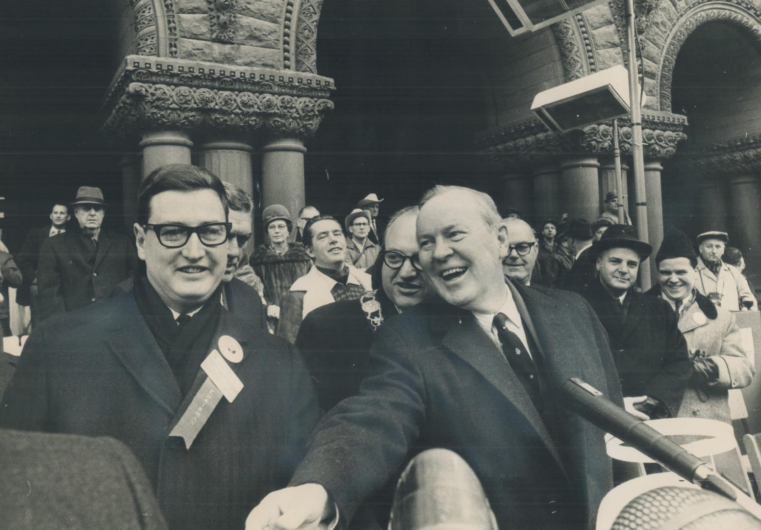 The parade makes a hit with Prime Minister Pearson as it passes the city hall