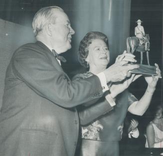 Receiving a souvenir at a dinner in Toronto last night honoring him after the close of the constitutional conference in Ottawa, Prime Minister Lester (...)