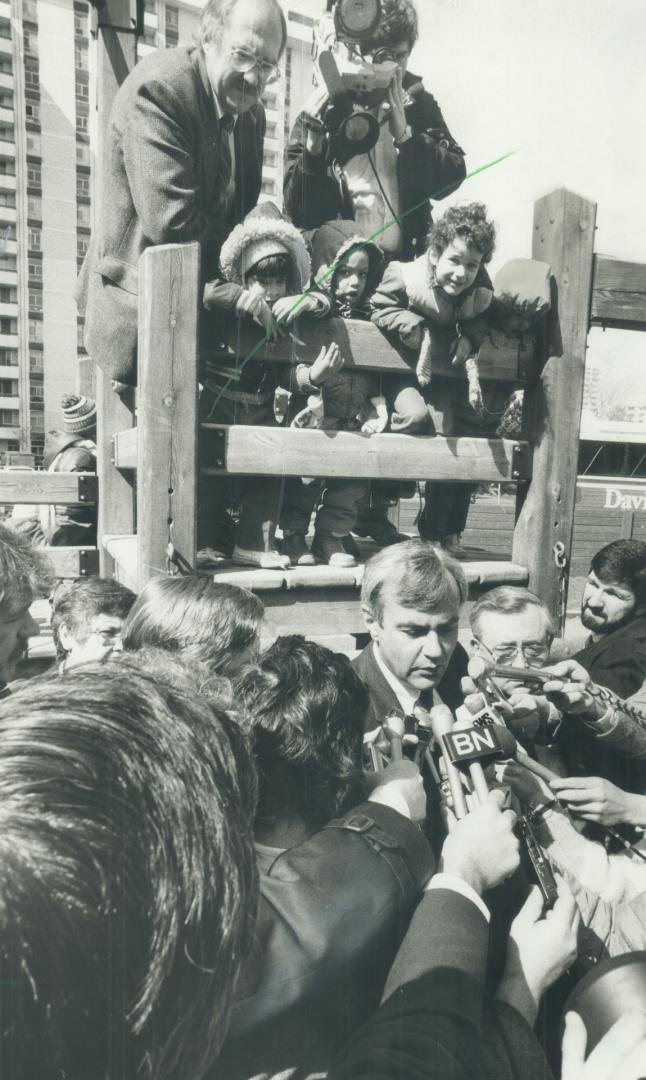 Close contact, Reporters surrounding David Peterson, above, enjoyed much better communication with the Liberal leader and his aides than with Premier Frank Miller and his handlers