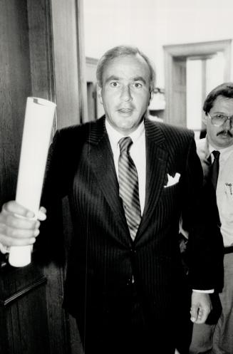 Triumphant return, Ontario Premier David Peterson heads to a news conference yesterday at Queen's Park after returning from Ottawa