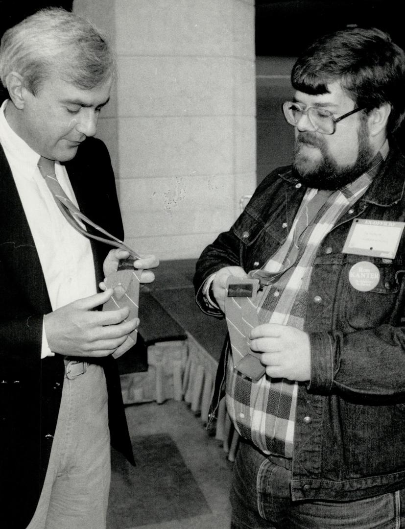 $10 a month forever, Premier David Peterson, left, and Toronto Liberal delegate Ian MacMillan inspect their red signature ties, trademark of the provincial party and now a fundraising symbol