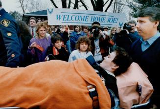 Happy homecoming, Joe Philion's aunt Connie Hawkins, left, stands next to his brother Danny as they join townspeople in welcoming the burn victim back to Orillia