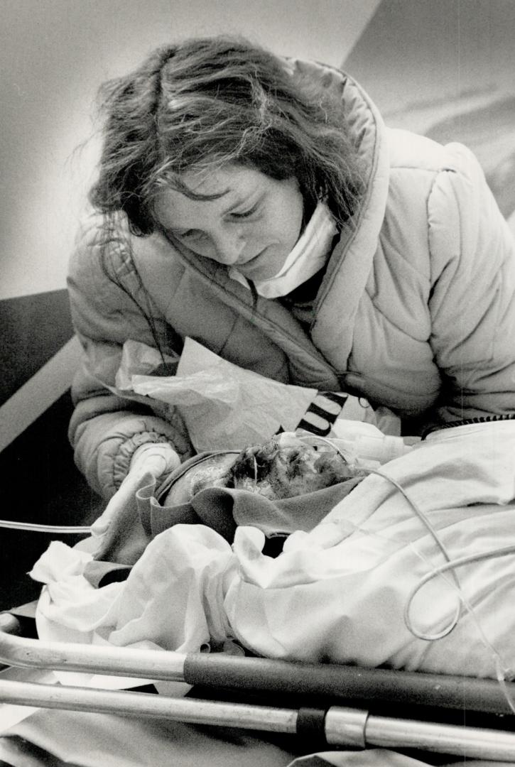 Delicate cargo, Burn victim Joey Philion, 14, gets words of encouragement from his mother, Linda Hawkins, yesterday before she joined him on a flight to a burn clinic in Boston