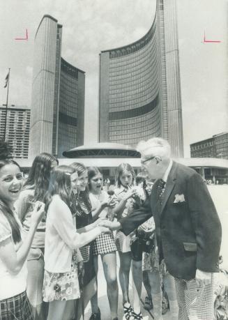 In the square named for him in front of City Hall, former Toronto mayor Nathan Phillips talk with visitors from St