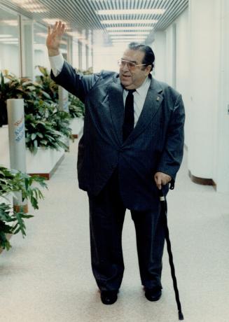 Joe says farewell, Ex-alderman Joe Piccininni waves goodbye as he walks down city Hall's alderman's alley