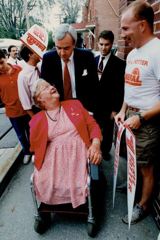 Fighting back, Premier David Peterson, in a tight election race, campaigns in Beaches-Woodbine yesterday with Liberal candidate Beryl Potter