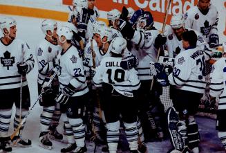 Leafs' goalie Felix Potvin is mobbed by mates after blanking Montreal 4-0 last night for his first NHL shutout