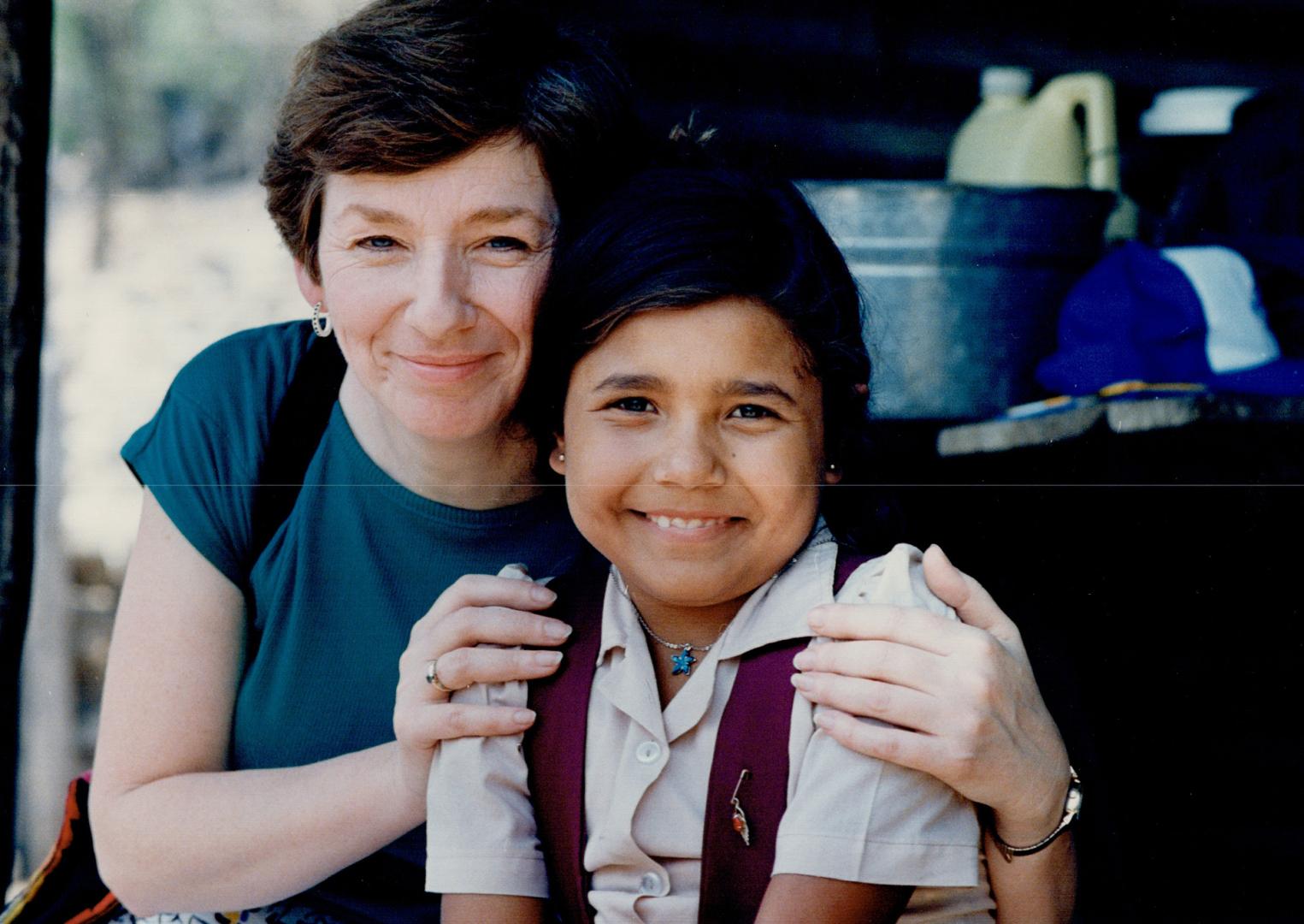 Mom and 'daughter', Sheila Potwin of Toronto cuddles her foster-daughter, Aura Morales, 9, in Casas Viejas, Guatemala