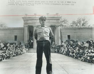 A police guard stands watch in front of the mausoleum in Memphis Tenn