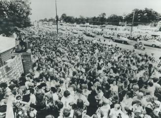 Crying, pushing and fainting, more than 10,000 mourners try to force their way into Graceland mansion to view body of rock' n' roll star Elvis Presley