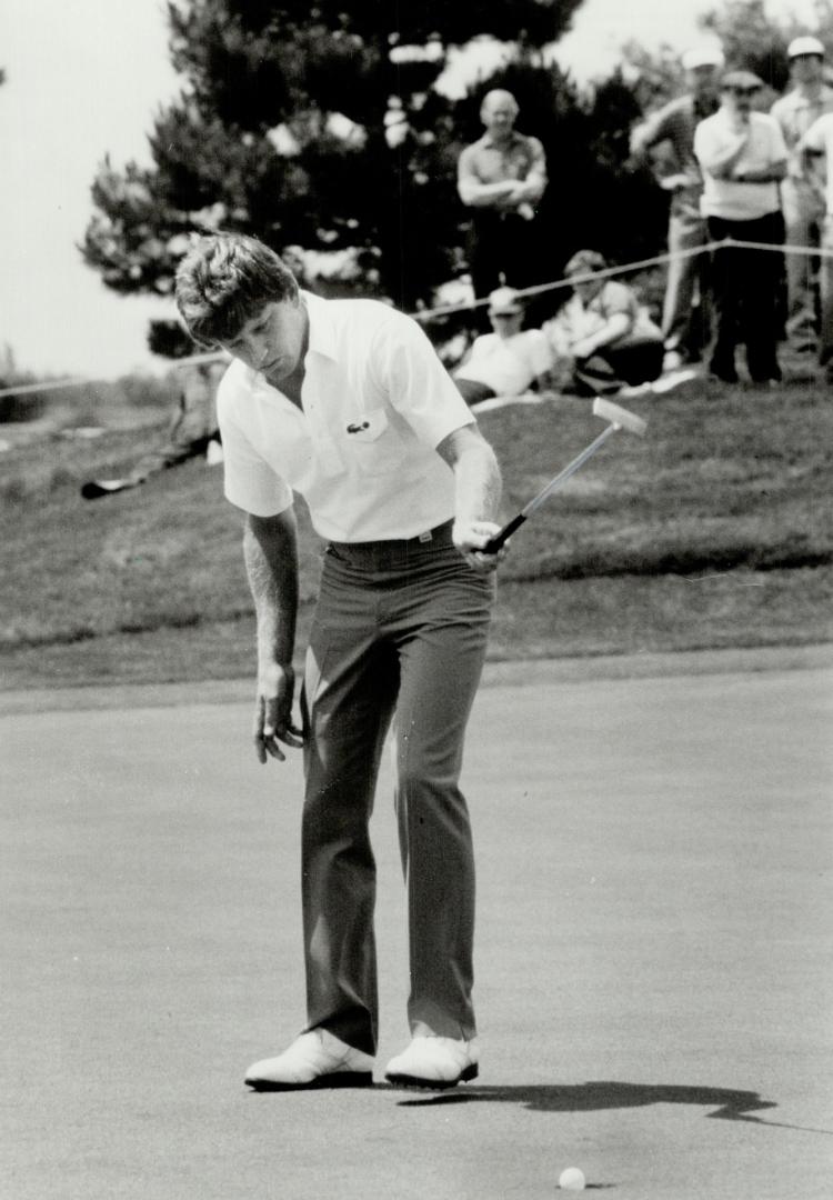 Early leader, Nick Price, seen here sinking a putt on the eighth to save par, leads Open with a five-under 67