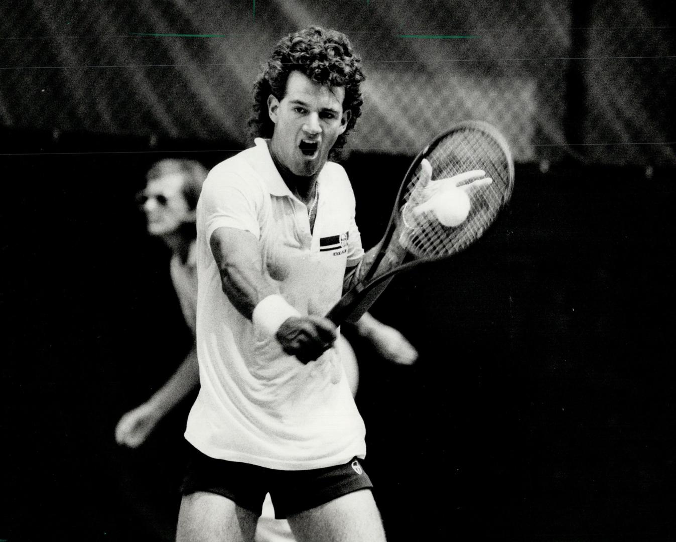 Strong backhand, Chris Pridham, one of Canada's promising tennis stars, puts a lot into his backhand stroke in a match at last month's Sun Life Nationals at the Ontario Racquet Club