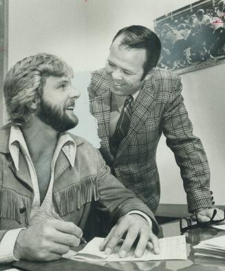 Welcome home. Happy head coach Leo Cahill (right) jokes with veteran Argonaut tight end Mel Profit as latter signs a new one-year contract to play for(...)