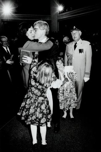 A Family affair, Premier Bob Rae stops in Convocation Hall yesterday to kiss his wife, Arlene, and get hugs from his daughters at his swearing-in ceremony