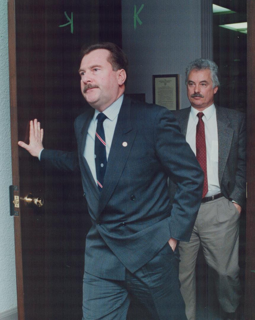 Grim faces: Metro Chairman Alan Tonks (left) and Councillor Brian Ashton leave talks with unionists Frank Savard and Andy Mele