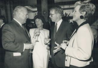 Symphony director George Woods talks with fellow director Liz Tory, John Tory, president of Thomson Corp